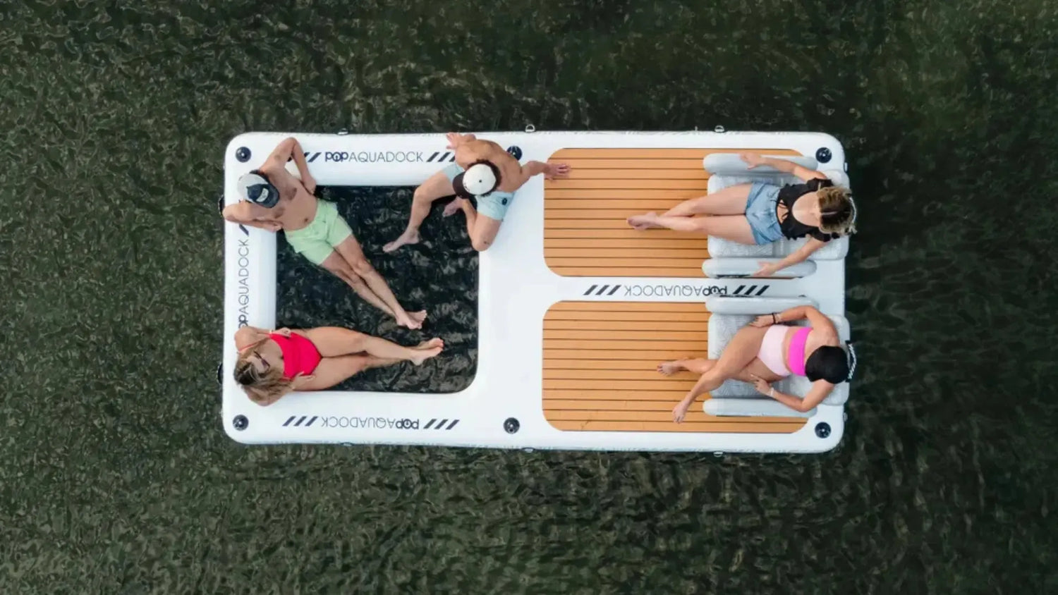 Inflatable popup aqua dock with group relaxing on water